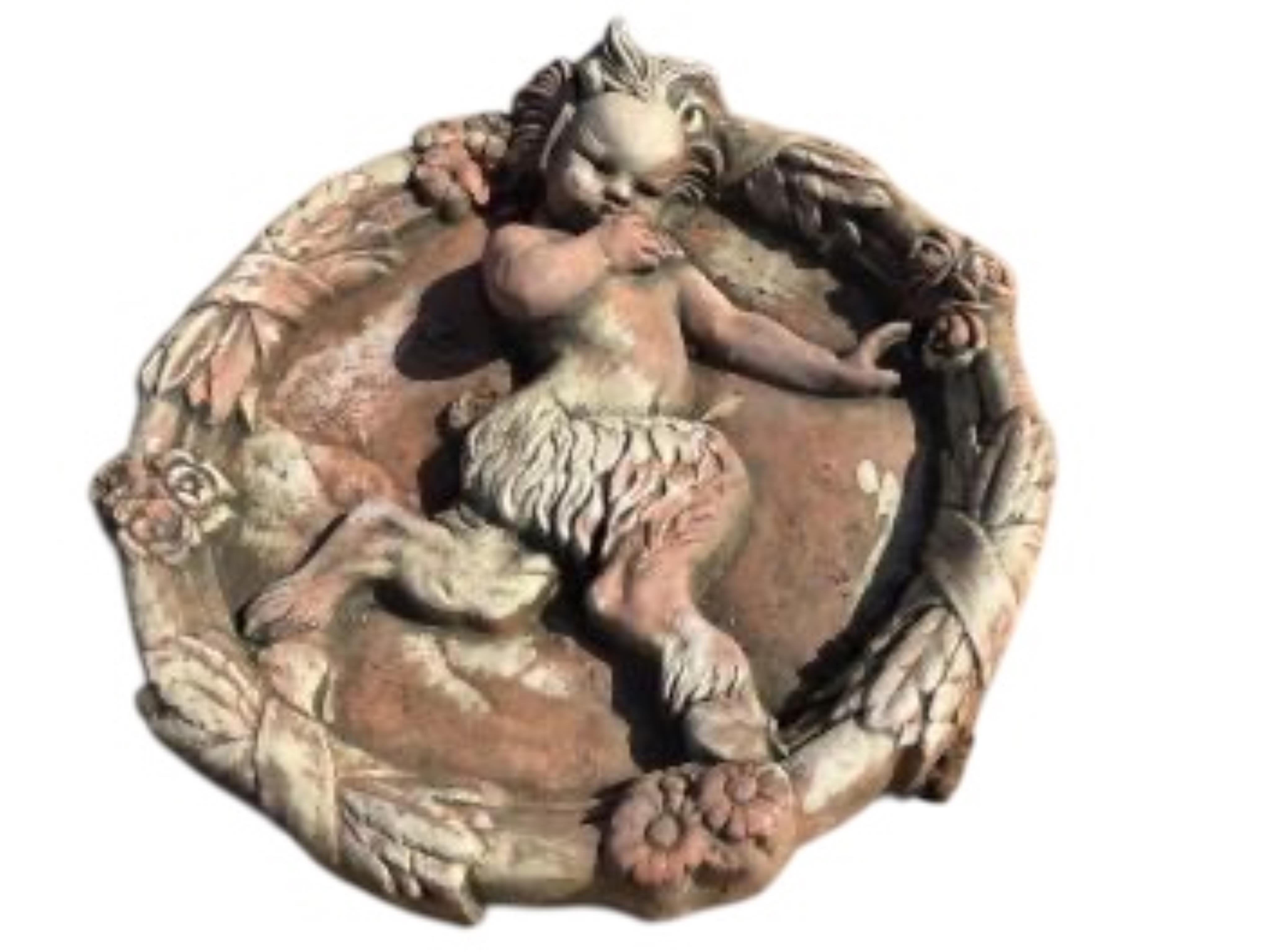 Five cast stone and terracotta garden wall plaques, largest diameter 41cm
